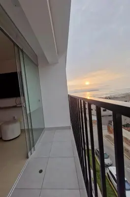 a balcony of a building with a view of the ocean at Departamento a un paso de playa Pulpos y Arica in Lurín