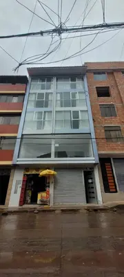 a tall building with an umbrella in front of it at La mansión in Cusco