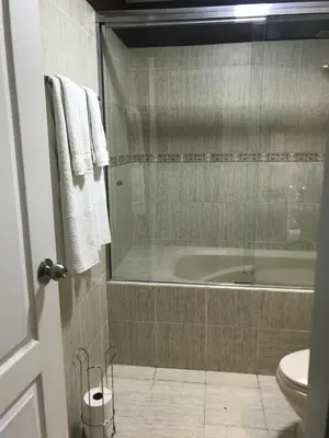 a bathroom with a bath tub and a toilet at Cozy Condo in Miraflores in Lima
