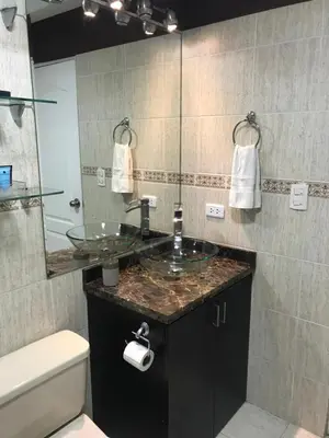 a bathroom with a sink and a mirror at Cozy Condo in Miraflores in Lima
