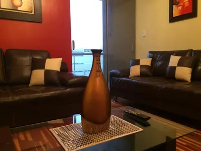 a large vase sitting on a table in a living room at Cozy Condo in Miraflores in Lima