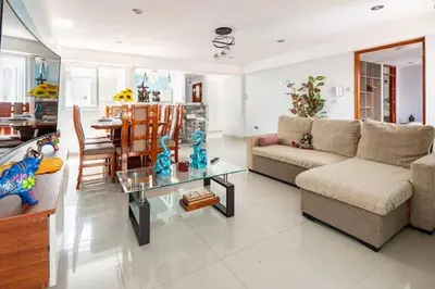 a living room with a couch and a table at Apartamento en Cuzco in Cusco