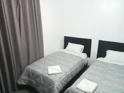 a bedroom with two beds with white pillows at Departamento 2 HABITACIONES 1A in Lima