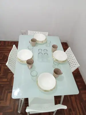 a white table with plates and cups on it at Departamento 2 HABITACIONES 1A in Lima