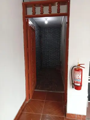 a hallway with a door and a fire extinguisher at Departamento 2 HABITACIONES 1A in Lima