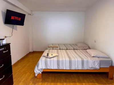 a bedroom with a bed and a sign that reads inertia at Hotel Krammer en San Ramón, Selva Central in San Ramón
