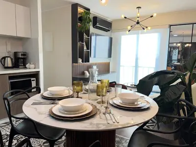a dining room table with plates and glasses on it at Design Apartment with city view! - Miraflores in Lima