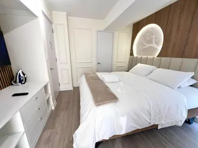 a white bedroom with a large bed and a counter at Design Apartment with city view! - Miraflores in Lima