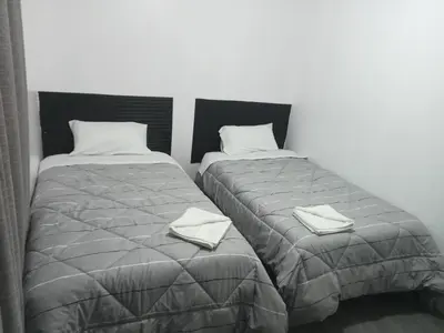 two beds sitting next to each other in a room at Habitación 02 CAMAS 1C in Lima
