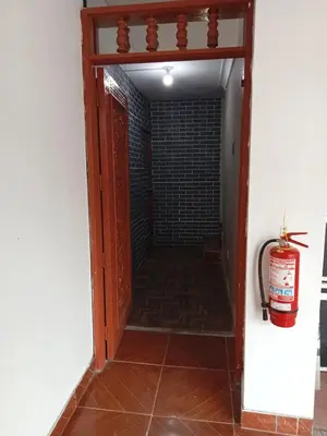 a hallway with a door and a fire extinguisher at Habitación 02 CAMAS 1C in Lima