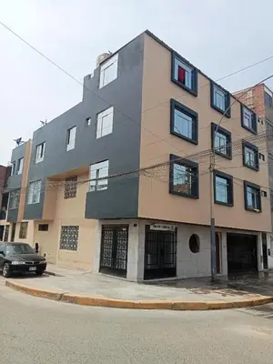 a building on the corner of a street at Habitación 02 CAMAS 1C in Lima