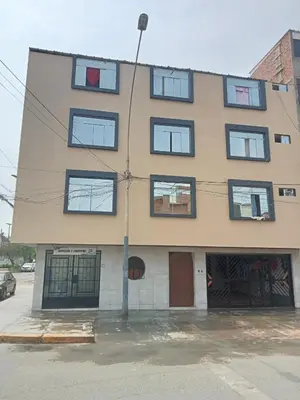 a building with many windows and a street light at Habitación cama QUEEN 1B in Lima