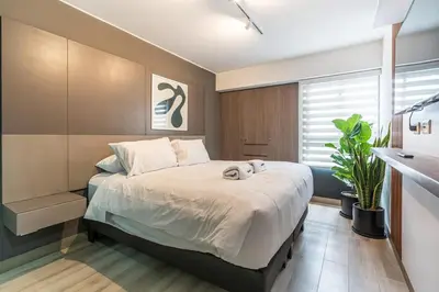 a bedroom with a bed with two stuffed animals on it at Gardenia by Geko in Lima