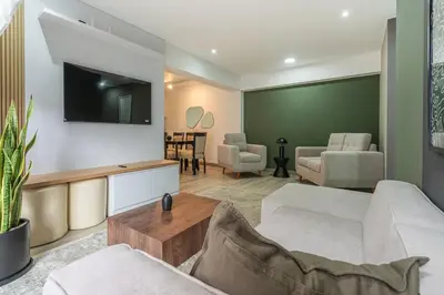a living room with a couch and a tv at Gardenia by Geko in Lima