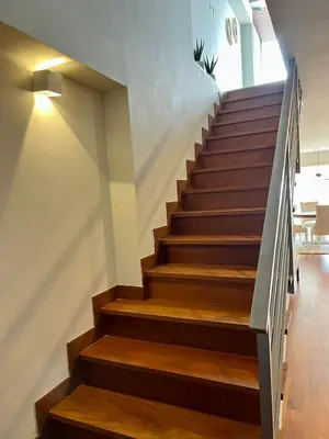 a staircase in a house with wooden flooring and wooden steps at Malecón Miraflores Luxury Penthouse in Lima