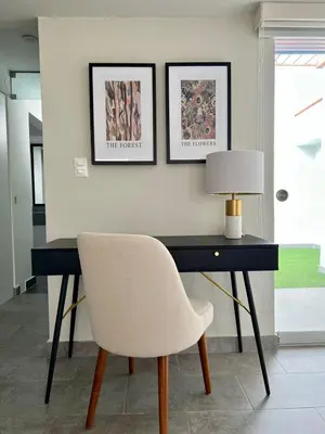 a desk with a chair and a lamp on it at Malecón Miraflores Luxury Penthouse in Lima