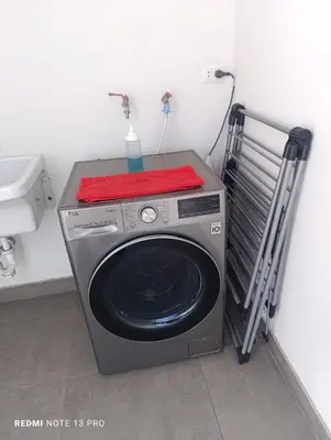 a washing machine with a red towel on top of it at Malecón Miraflores Luxury Penthouse in Lima