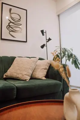 a green couch in a living room with a plant at Apartment 2BDR next to Javier Prado - San Isidro in Lima