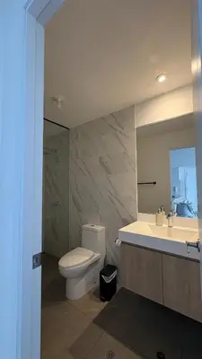 a bathroom with a toilet and a sink and a mirror at Apartment 2BDR next to Javier Prado - San Isidro in Lima