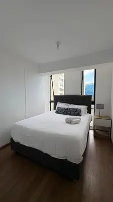a bedroom with a large bed with white sheets at Apartment 2BDR next to Javier Prado - San Isidro in Lima