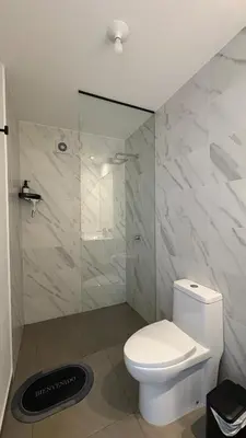 a bathroom with a toilet and a glass shower at Apartment 2BDR next to Javier Prado - San Isidro in Lima