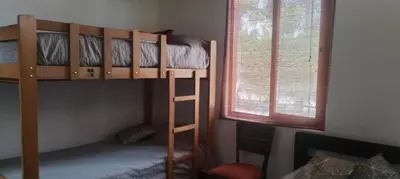 a bedroom with two bunk beds and two windows at Bungalow 23 in El Carmen