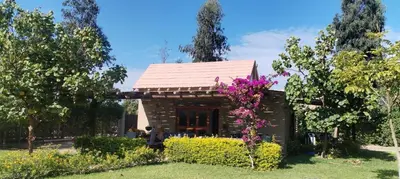 a small house in a garden with flowers at Bungalow 23 in El Carmen