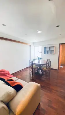 a living room with a couch and a table at Lindo departamento en Miraflores Parque Kennedy in Lima