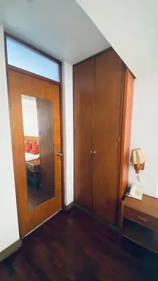 a room with a wooden door and a bedroom at Lindo departamento en Miraflores Parque Kennedy in Lima