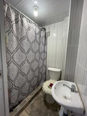 a bathroom with a sink and a toilet and a shower at Minidepartamento de 3 pisos, completo y comodo in Cusco