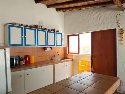 a kitchen with white cabinets and blue cupboards at Casa bonita en Playa Los Lobos in Cerro Azul