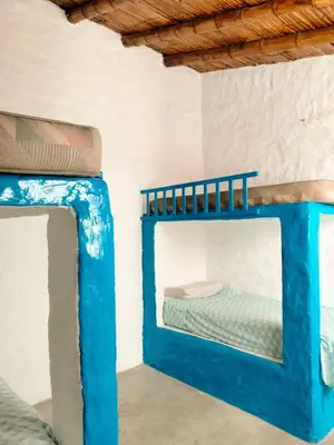 two bunk beds in a room with a mirror at Casa bonita en Playa Los Lobos in Cerro Azul