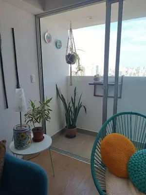 a living room with chairs and plants at Acogedor y cómodo departamento de 2 Habitaciones en Magdalena in Lima