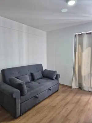a couch in a living room with a curtain at Apartamento Mary in Lima