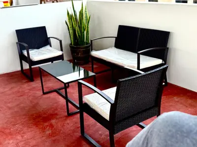 three chairs and a table in a room at Cuzco Lodgement in Lima