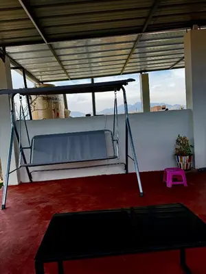 a swing in a room with a red carpet at Cuzco Lodgement in Lima