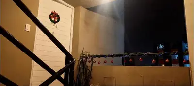 a staircase with a christmas wreath on a wall at Confort Maruja in Lima