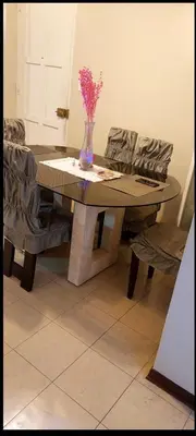 a table with a vase of flowers on top of it at Confort Maruja in Lima
