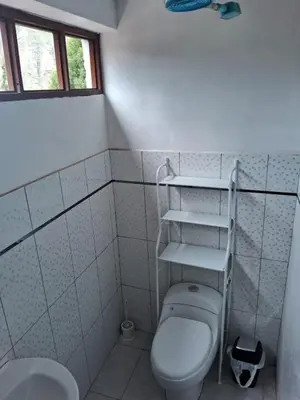 a bathroom with a toilet and a sink at Guest House Aylluq Wasin in Urubamba