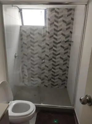 a bathroom with a shower and a toilet at Departamento de 3 habitaciones in Lima