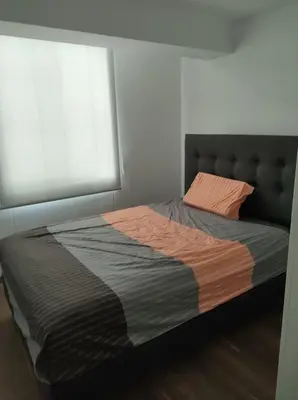 a large bed in a bedroom with a window at Departamento de 3 habitaciones in Lima
