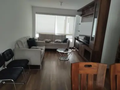a living room with a couch and a table at Departamento de 3 habitaciones in Lima