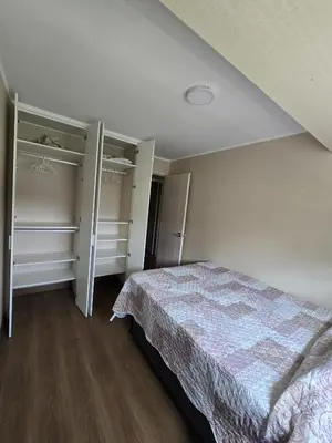 a bedroom with a bed and two walk in closets at AMPLIO DEPARTAMENTO EN JESÚS MARÍa in Lima