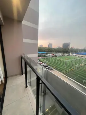 a balcony with a view of a baseball field at AMPLIO DEPARTAMENTO EN JESÚS MARÍa in Lima