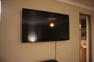 a flat screen tv hanging on a wall at Casa Canal - 3 cuadras de la Plaza de Armas in Cusco
