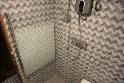 a shower stall with a shower door in a bathroom at Casa Canal - 3 cuadras de la Plaza de Armas in Cusco