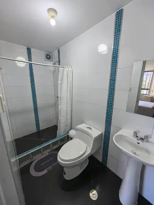 a bathroom with a toilet and a sink at Hotel Douce Nuit in Huancayo