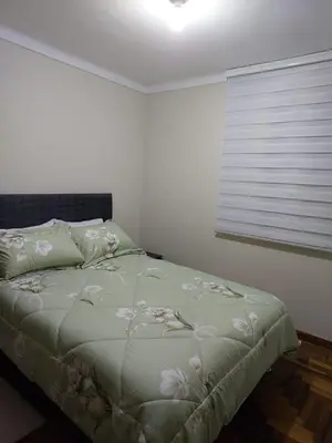 a bedroom with a bed with flowers on it at JTM Apartament in Cusco