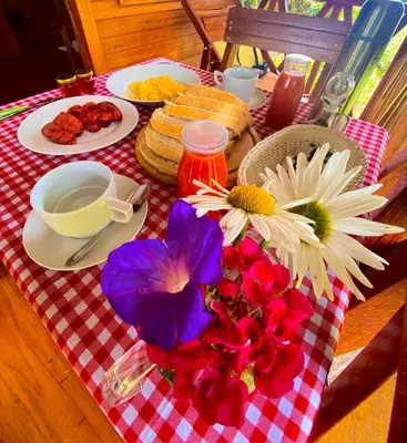 a table with a plate of food and flowers on it at Yoly cabaña in San Francisco