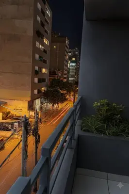 a view of a city street at night from a balcony at Departamento en el Corazón de Miraflores Peru in Lima